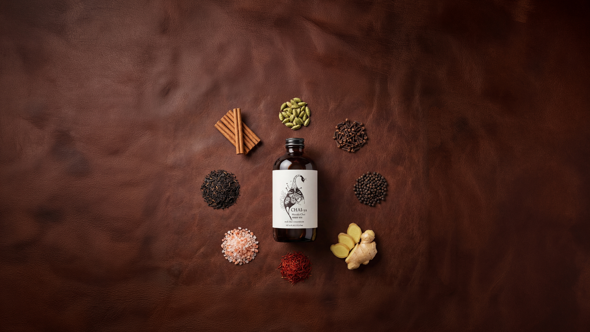 Masala chai concentrate bottle with traditional Indian spices – cinnamon, cardamom, cloves, ginger, black pepper, and saffron on rustic brown surface.